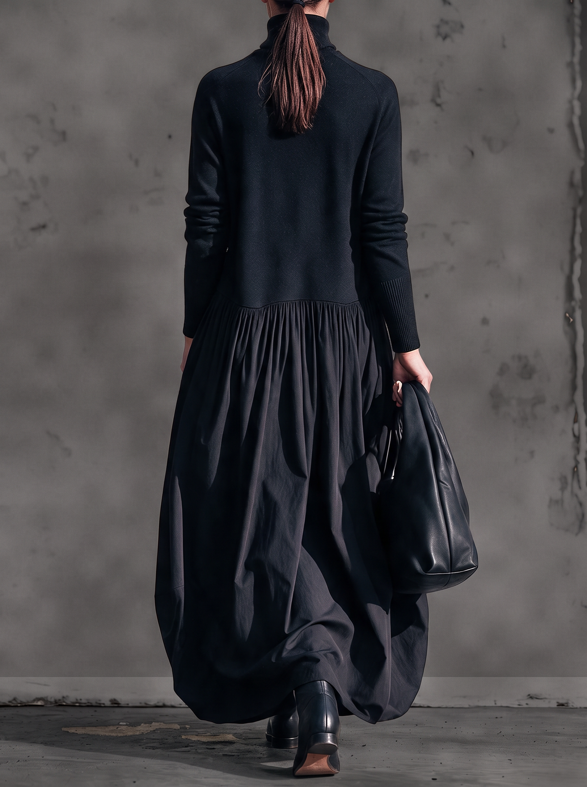 Back view of the black dress on a model with a ponytail, showing the gathered waist seam 3