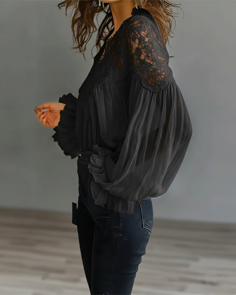 Side view of black blouse showing floral lace shoulder panel and sheer gathered sleeve 7