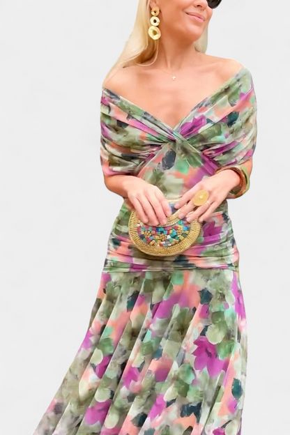 Close-up of the green, pink and purple floral version worn off the shoulder with a twisted front and ruched waist. 10
