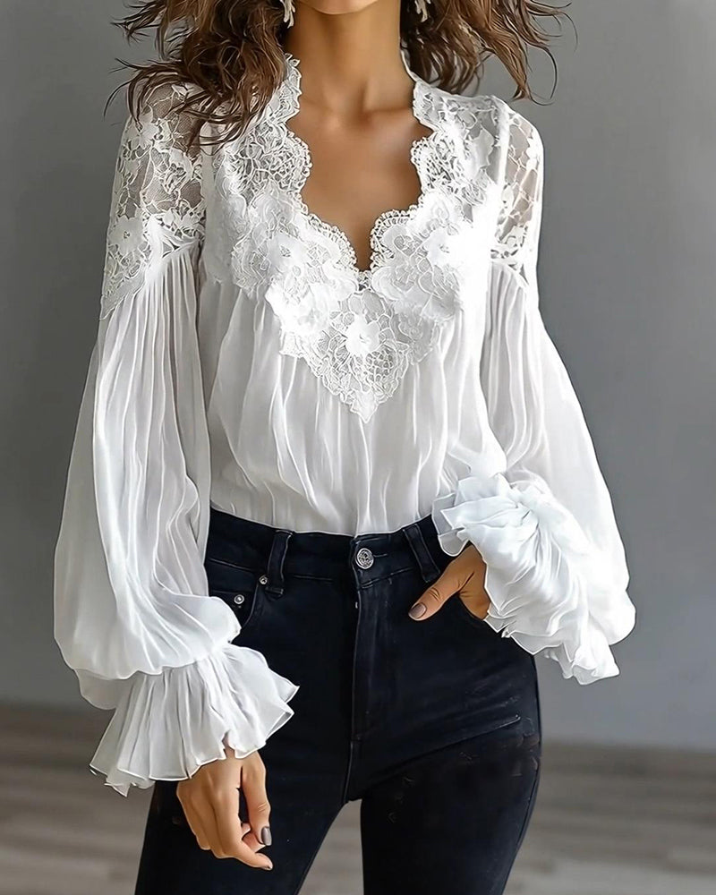 Wider front view of white lace-trimmed blouse with sheer balloon sleeves, tucked into dark jeans 4
