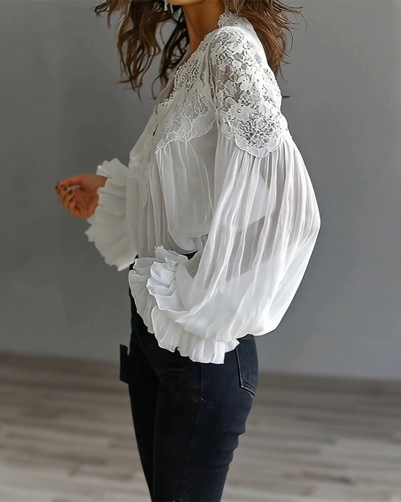 Side view of white blouse showing lace shoulder yoke and sheer billowing sleeve with ruffled cuff 2
