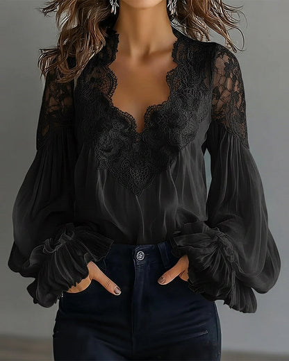 Black version of the lace blouse, front view with scalloped V-neck and ruffled cuffs 6