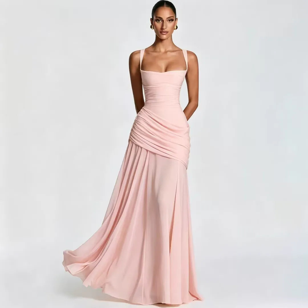Soft pink dress on a model, front view with square neckline, side draping and flowing chiffon-like skirt. 19