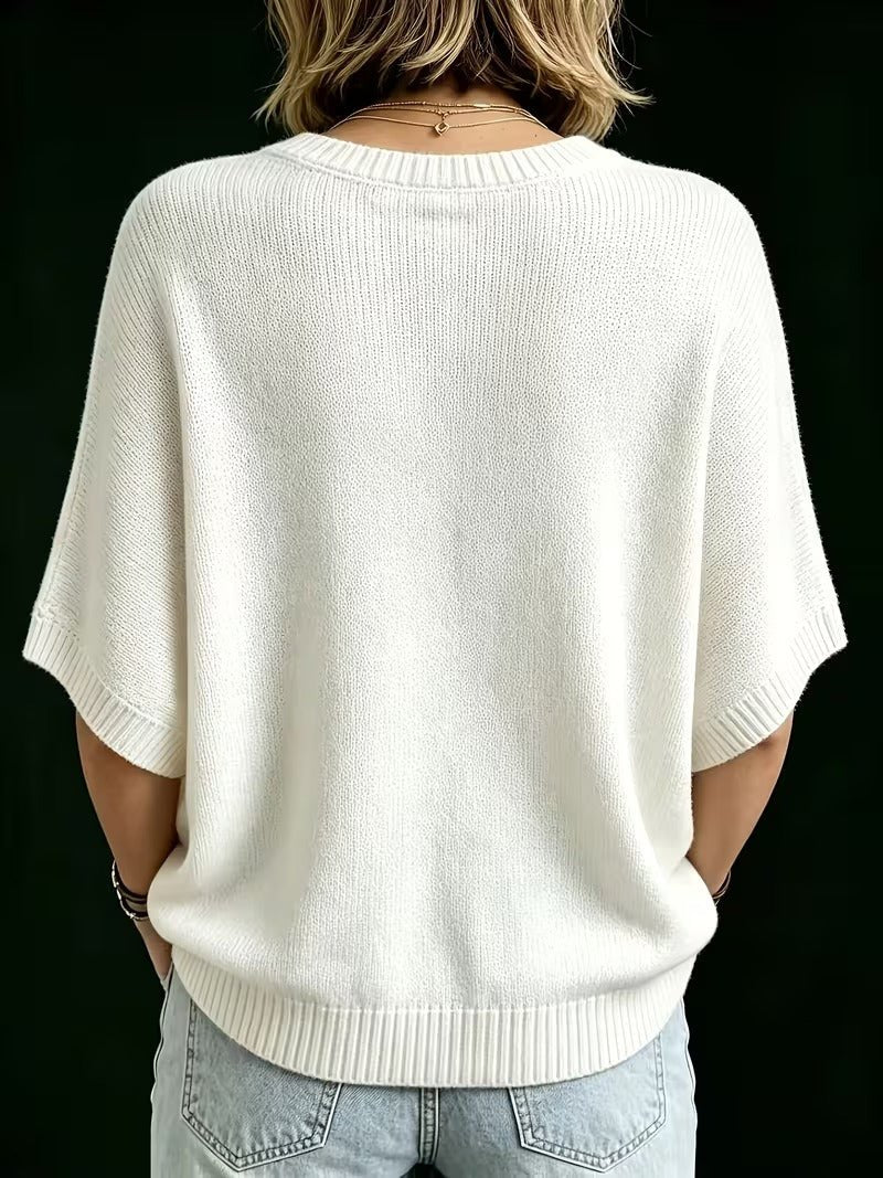Back view of the cream knit batwing top on a model, showing the ribbed round neckline, wide sleeves and hem. 25
