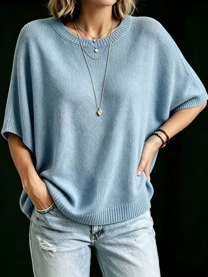 Light blue knit top worn with one hand in a jeans pocket and the other on the hip. 15