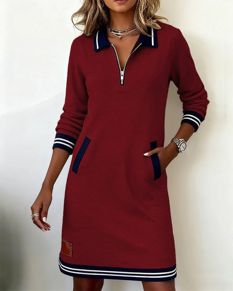 Model wearing the burgundy version with navy trim and a half zip, one hand in a pocket 5