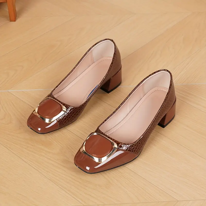 Flat lay of a pair of brown loafers on a wooden floor, showing the soft pale insole 4