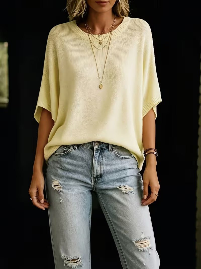 Pale yellow knit top worn by a model with ripped light-wash jeans, showing the relaxed fit and short sleeves. 5