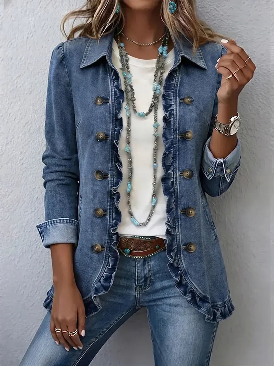 Blue denim version of the ruffle-trimmed jacket with bronze-toned buttons, worn open over a white top with layered turquoise necklaces. 7