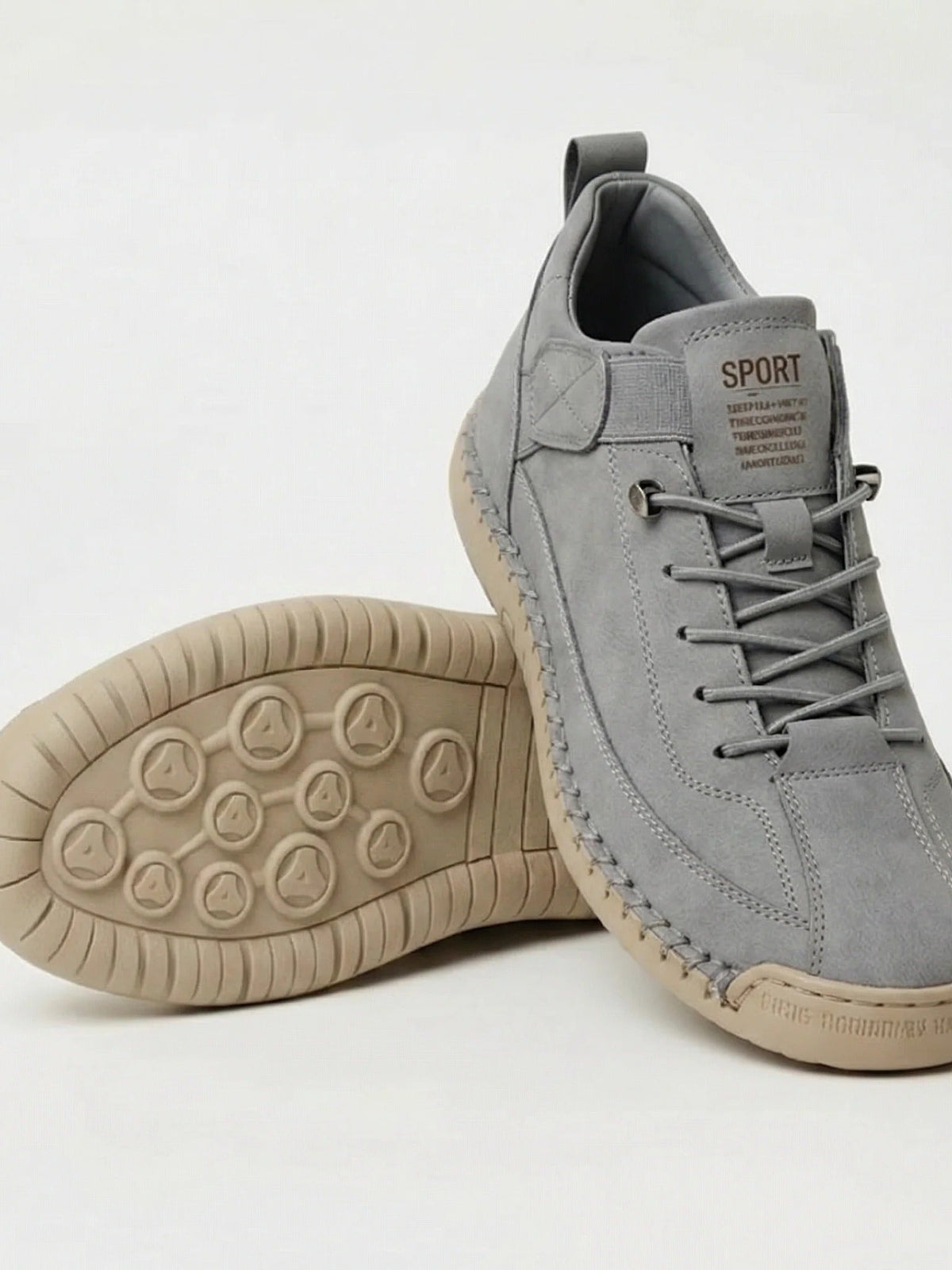 Light grey trainers with a beige sole, one shoe leaning on the other to show the tread 17