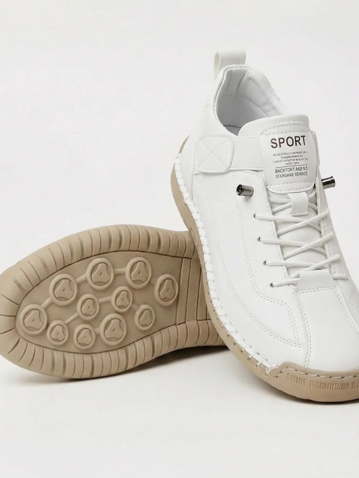 White trainers with a beige sole and elastic laces, one shoe tilted to show the tread 4