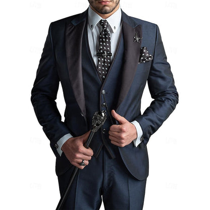 Model in a navy three-piece suit with satin peak lapels, spotted tie and pocket square, gripping a skull-topped cane. 2