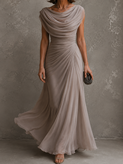 Three-quarter view of the taupe dress in motion, showing the layered chiffon skirt swirling out from the ruched waist. 8