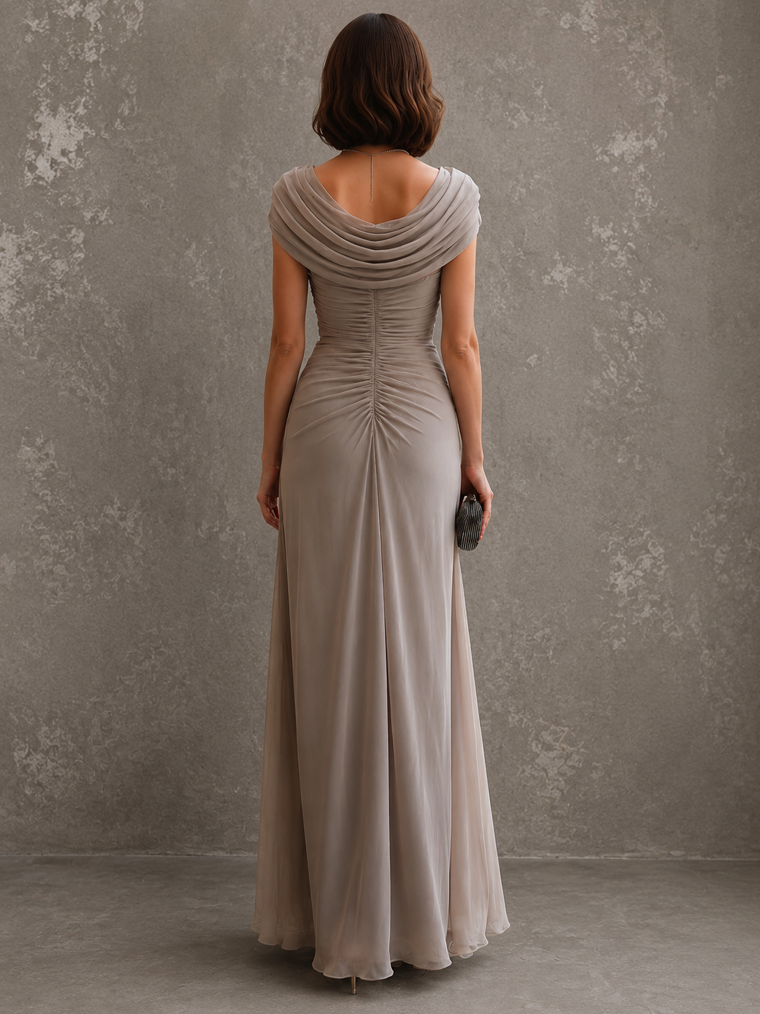 Back view of the taupe maxi dress, showing the draped back neckline and the centre ruching that runs down the back. 9