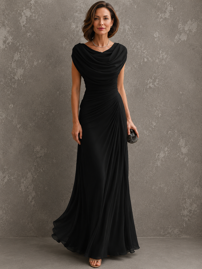Model standing front-on in the black version of the dress, showing the draped cowl neckline, ruched waist and floor-length chiffon skirt. 2