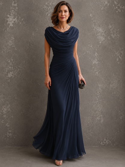 Model in the navy blue version of the long sleeveless gown, showing the cowl drape at the neckline and ruched waist. 4