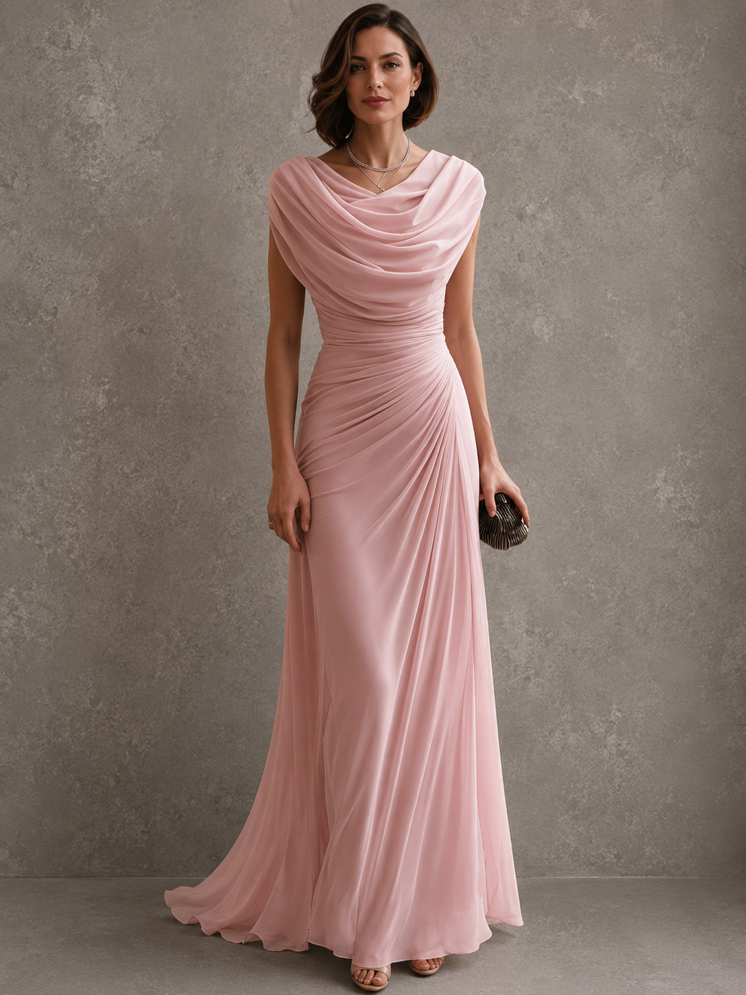 Model wearing the dusty pink version of the sleeveless maxi dress, with soft cowl draping, a gathered waist and a flowing hem. 3