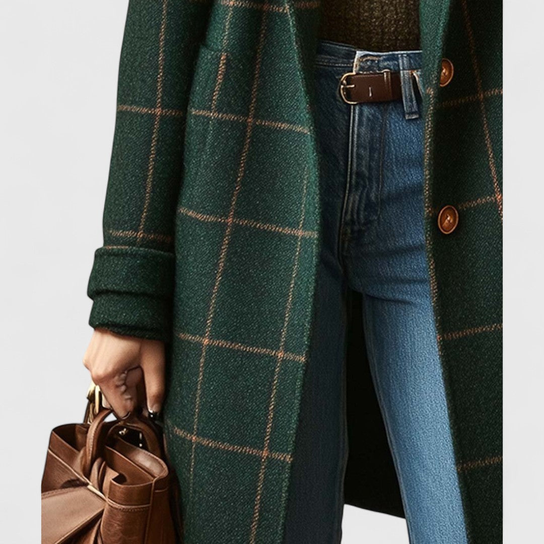 Detail of the coat's left side with patch pocket and turned-back cuff, worn with jeans, a brown belt and a leather bag. 4