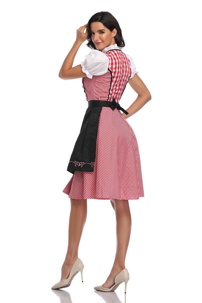 Back view of a red gingham dirndl with a black apron tied in a bow, puff sleeves and ruffled collar. 2