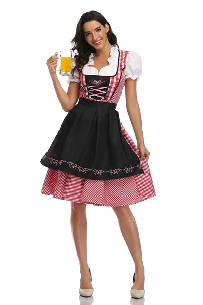 Model with a beer glass wearing a red gingham dirndl with a black embroidered apron and pink criss-cross lacing. 9