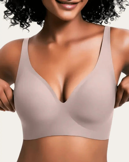 Model wearing the smooth wireless bra in a soft dusty taupe-pink shade, front view with deep V neckline. 4