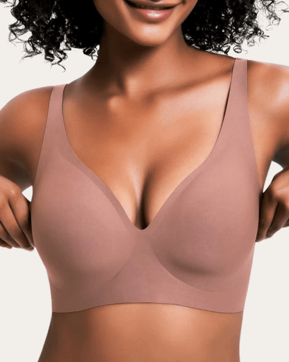 Model wearing the seamless V-neck bra in a plain dusty rose shade, front view. 8
