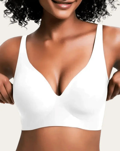 Front view of the seamless wireless bra in plain white, worn by a smiling model. 5