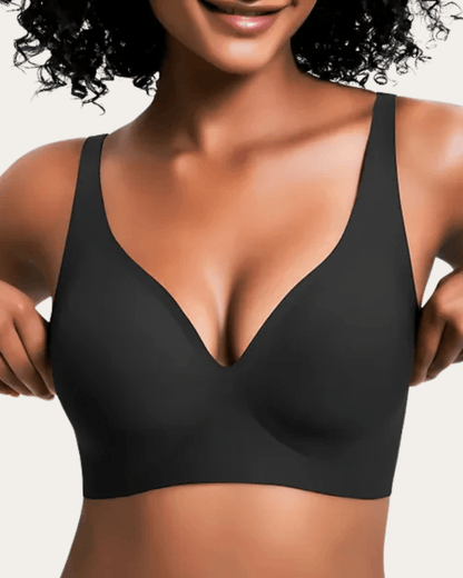Model wearing the plain black seamless V-neck bra with wide straps, shown from the front. 9