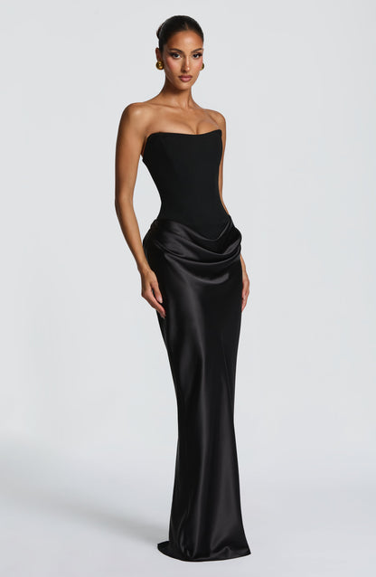 Black corset maxi dress with satin cowl skirt, angled three-quarter view showing the sweetheart neckline 24