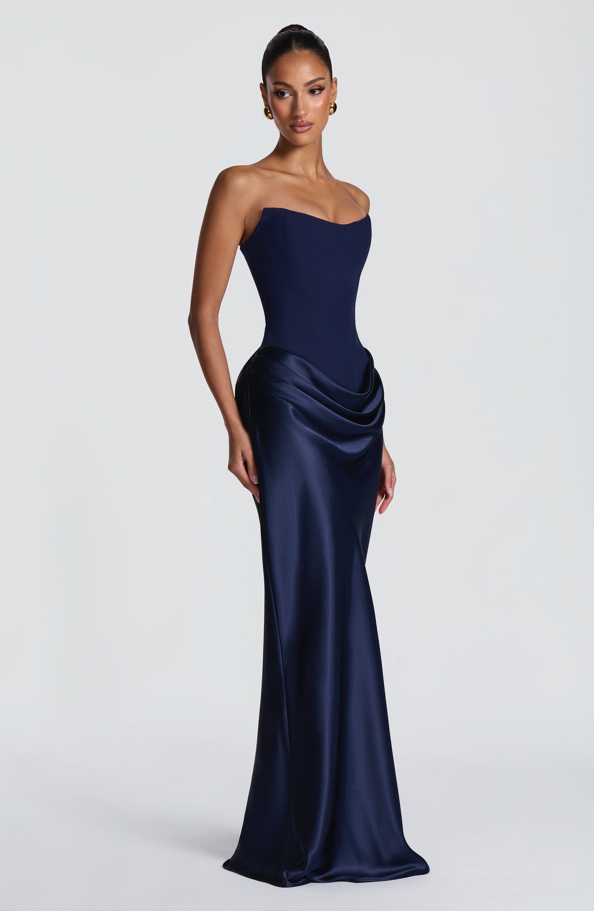 Three-quarter view of the navy corset gown on a model, showing the side drape 43