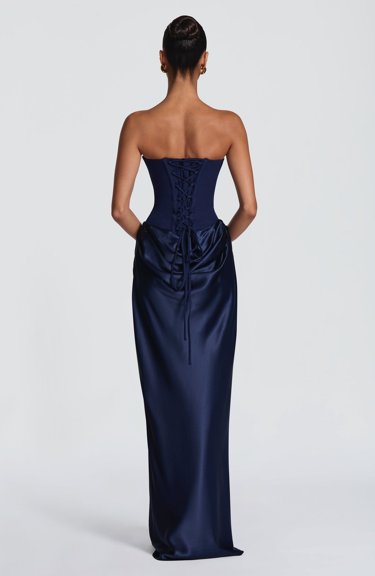 Back view of the navy gown showing the lace-up corset back and trailing ties 44