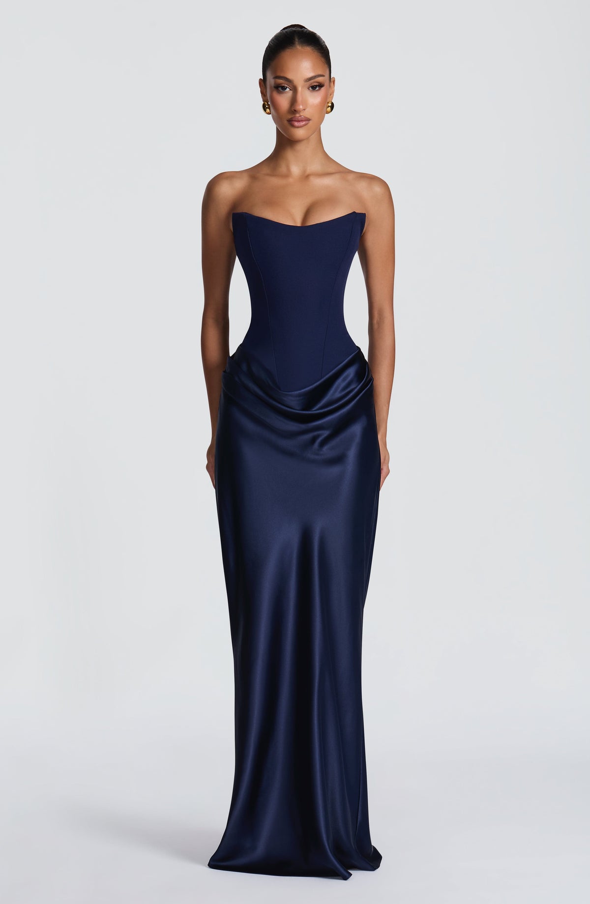 Model facing the camera in the navy strapless corset gown with draped satin skirt 42
