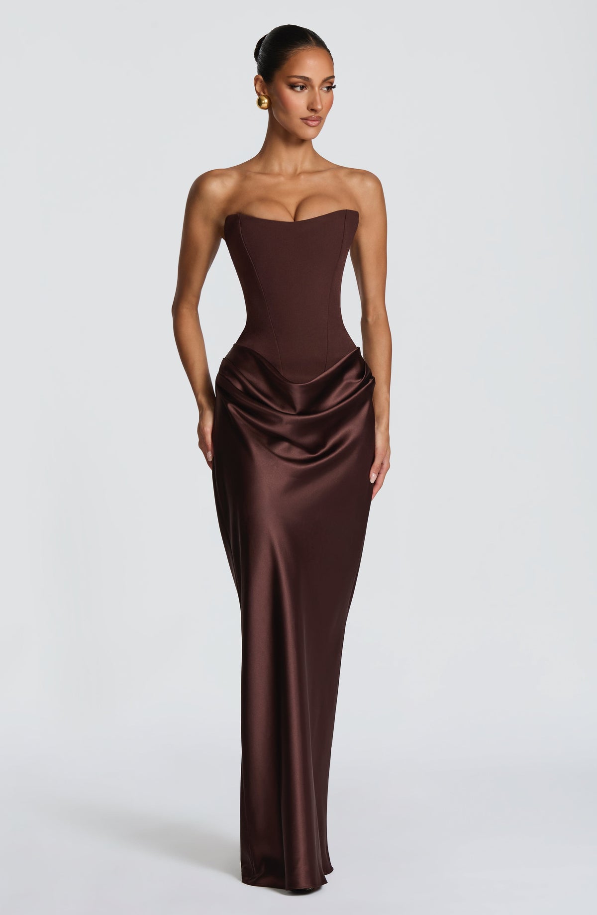 Full-length front view of the brown dress without the scarf, hair in a sleek bun 5