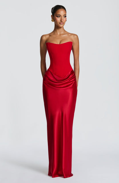 Front view of the red corset dress with hands by the sides and a long satin skirt 18