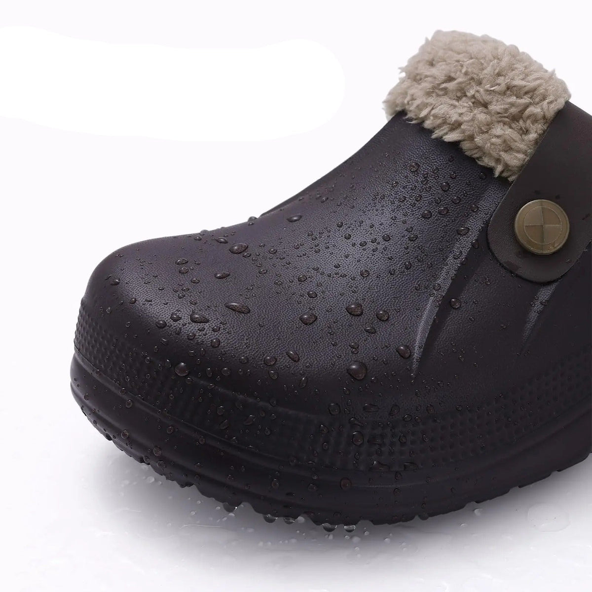 Close-up of a dark brown clog toe covered in water droplets, showing its waterproof surface 7