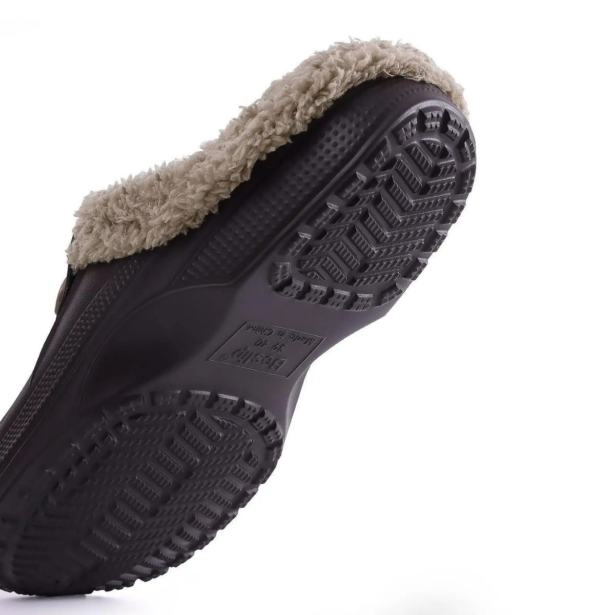 Underside of a dark brown clog showing the chevron-patterned non-slip tread and the fleece lining edge 9