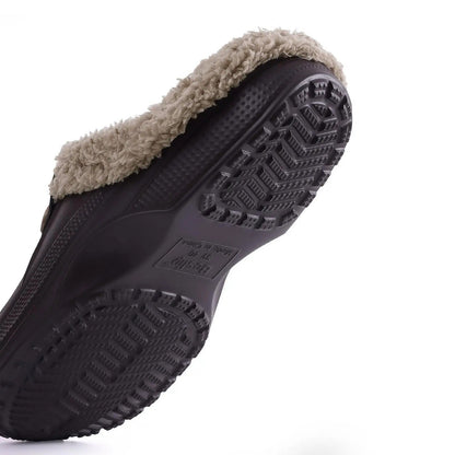 Underside of a dark brown clog showing the chevron-patterned non-slip tread and the fleece lining edge 9