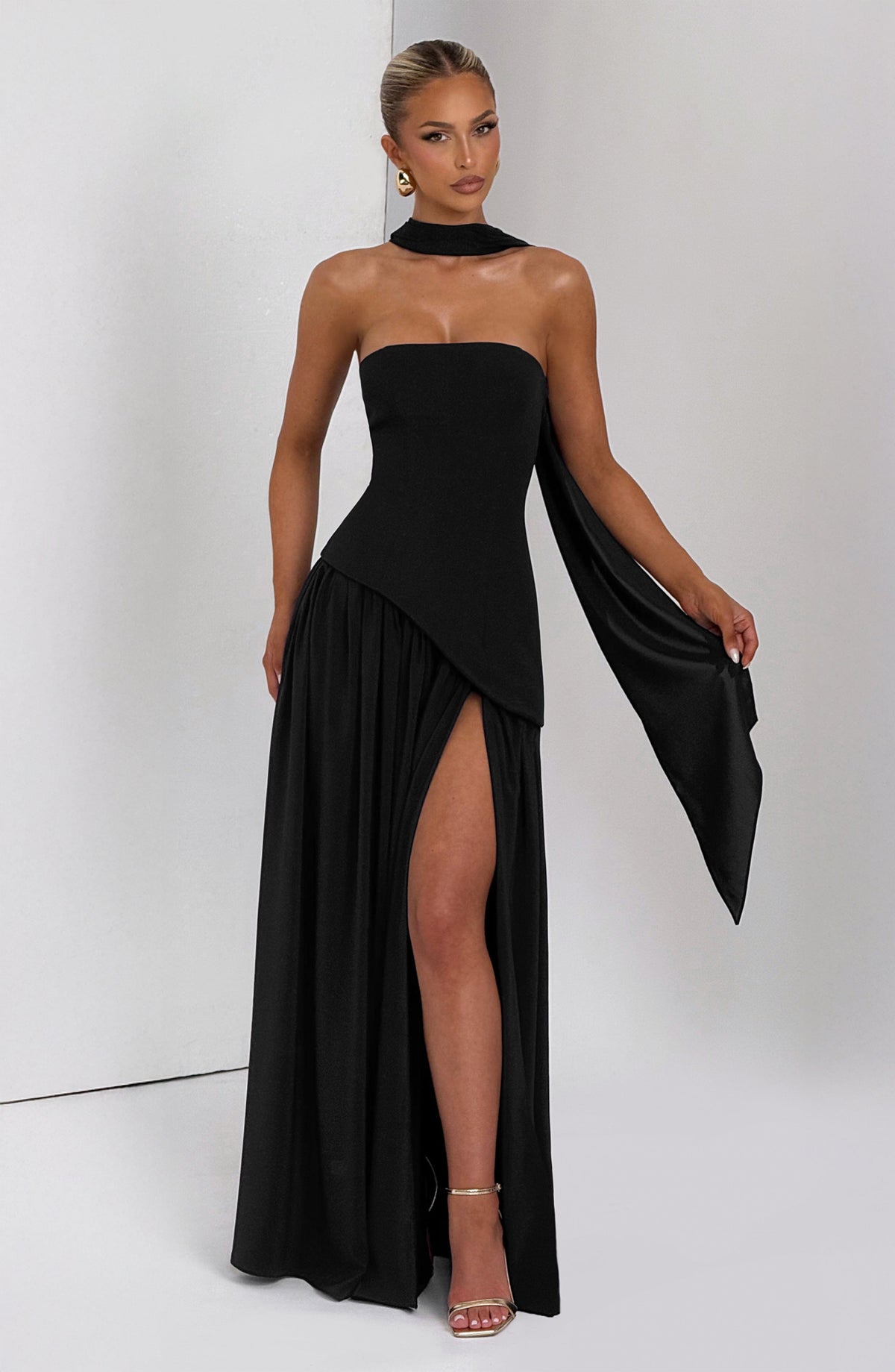 Black strapless maxi dress with scarf held out to the side, showing the high leg slit 10