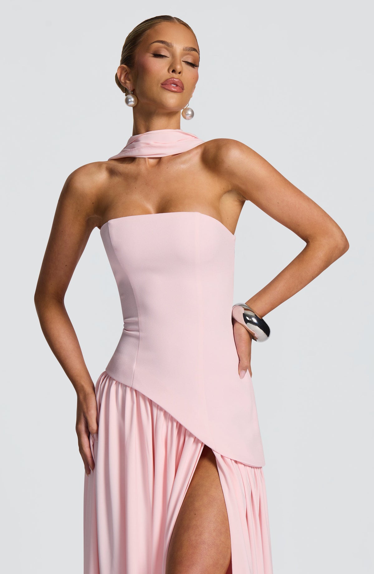 Close-up of pink strapless bodice with draped scarf neckline and asymmetric waist seam 24