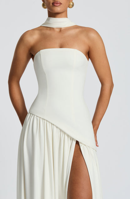 Close-up of cream strapless bodice with scarf neckline and gathered skirt below 36