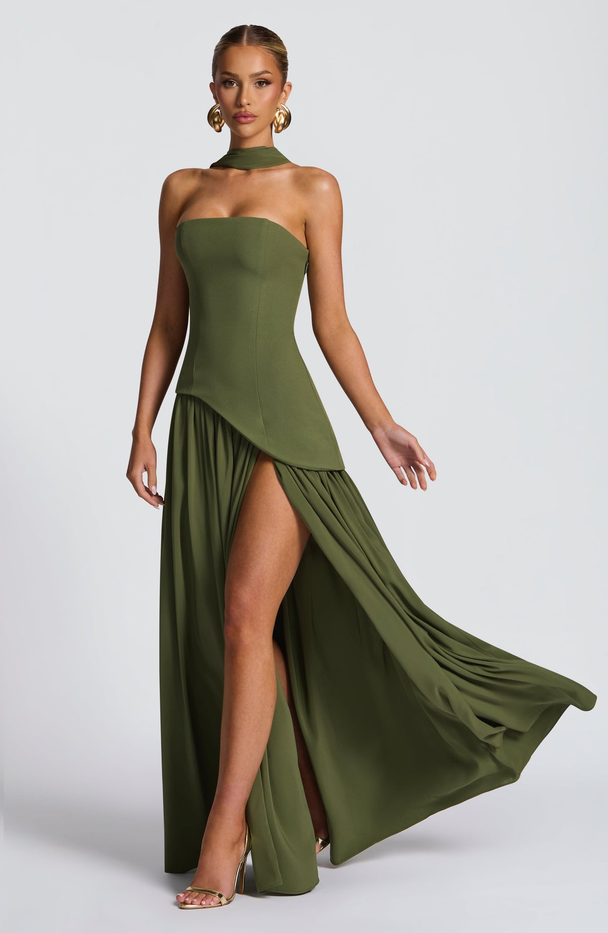 Olive green dress showing a flowing, gathered skirt with high slit in movement 31