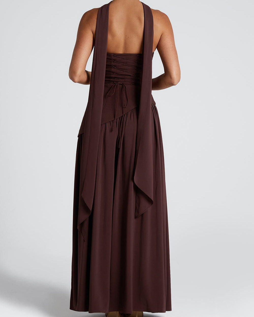 Back view of brown maxi dress with long scarf draped down the back and lace-up corset detail 3