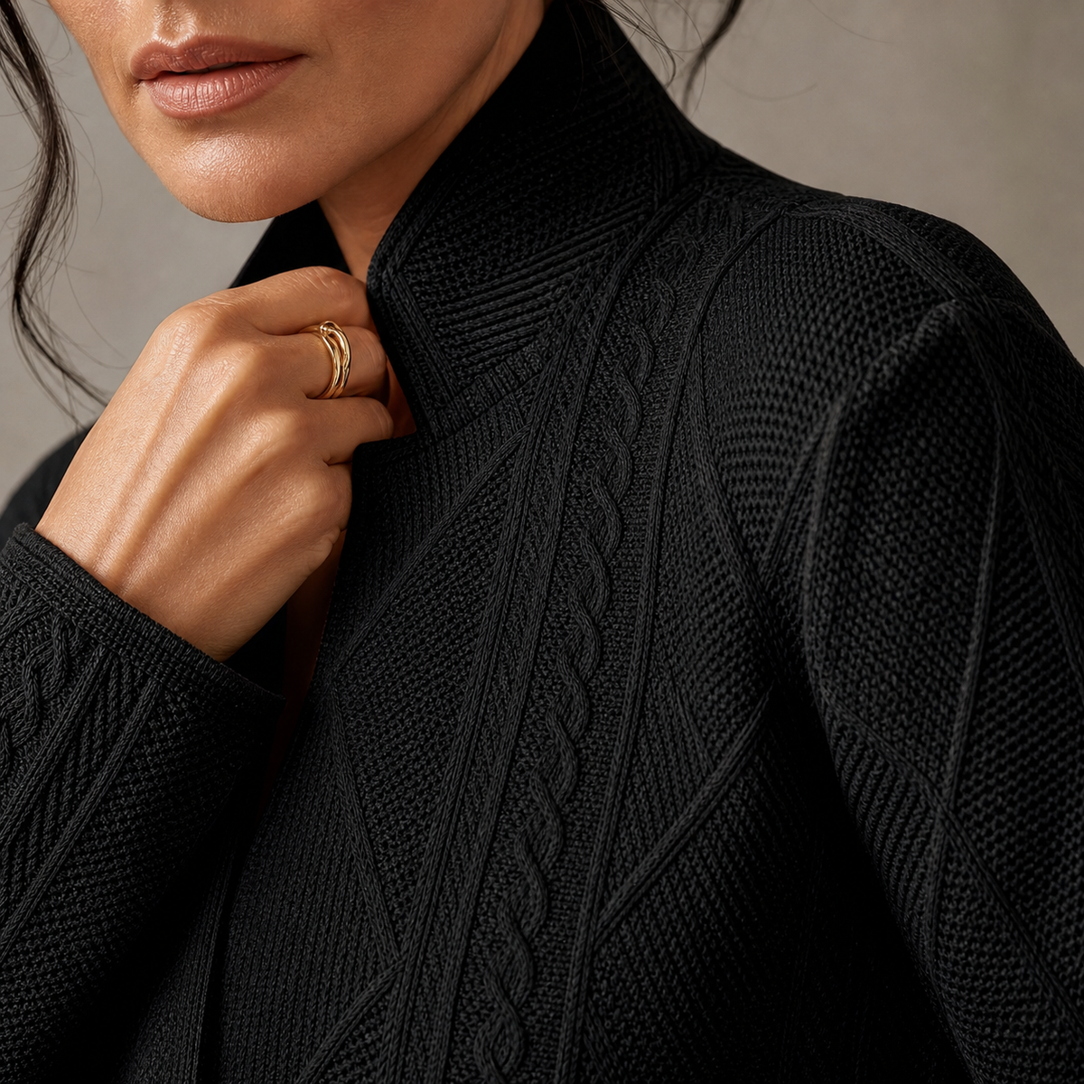 Close-up of the black blazer's stand collar and woven cable and diamond texture 12