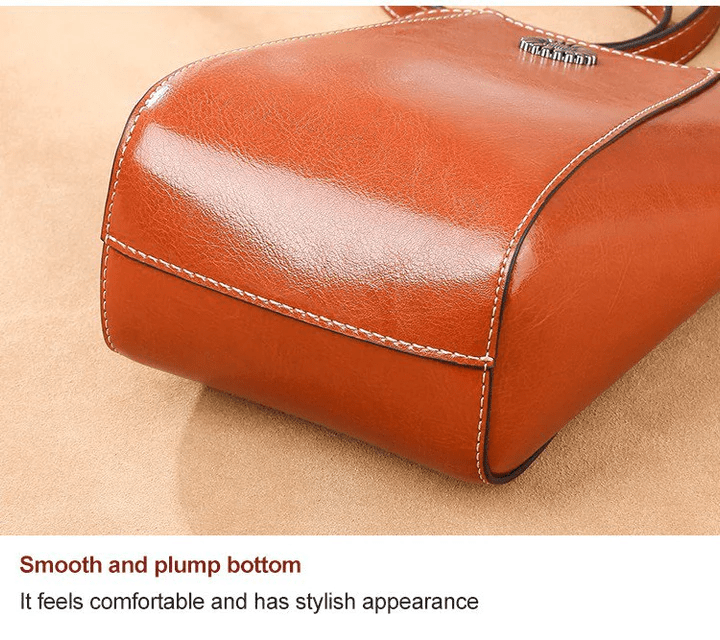 Close-up of the tan bag's smooth, rounded base with neat edge stitching 11