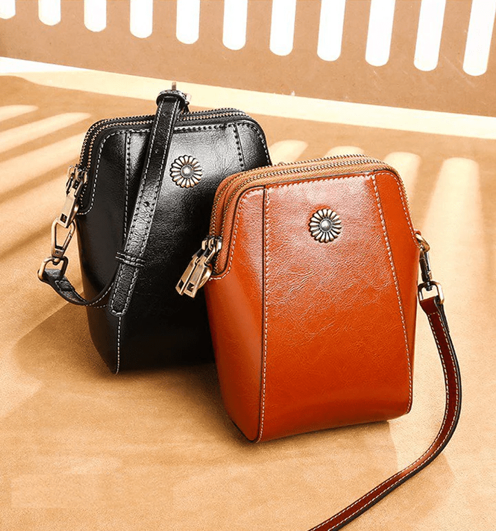 Black and tan versions of the bag side by side on a sunlit surface 2