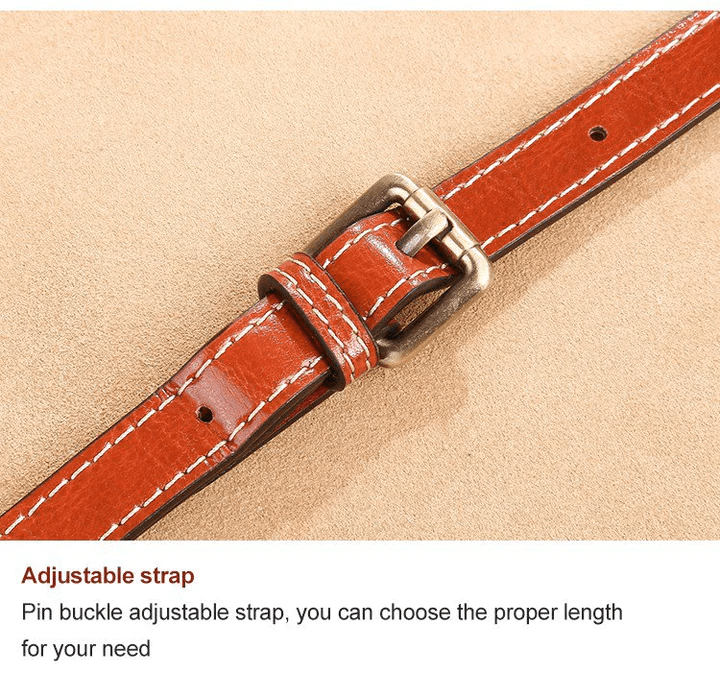 Close-up of the tan strap's pin buckle and punched adjustment holes 12