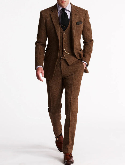 Model walking in the warm rust-brown herringbone tweed suit, waistcoat with pocket-watch chain, striped shirt and black tie 1