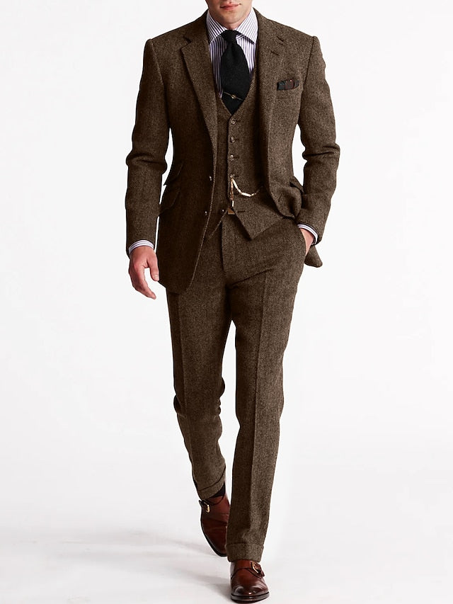 Model in the darker chocolate-brown herringbone version, hand in trouser pocket, with waistcoat chain and cuffed trousers 3