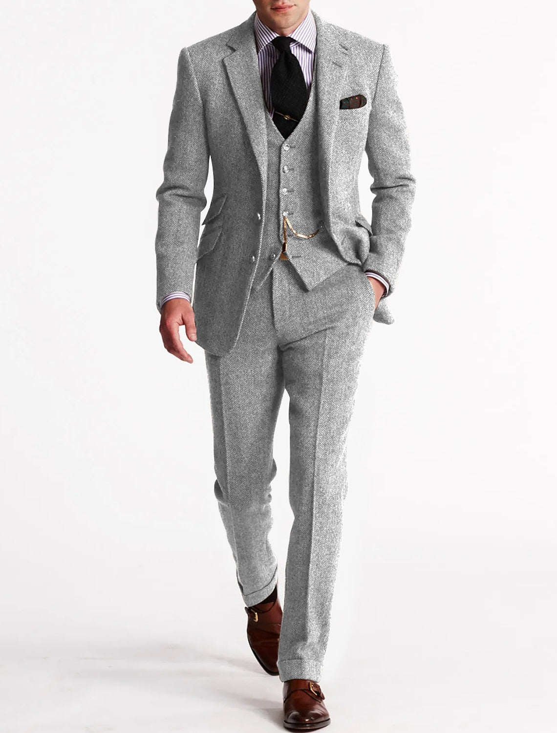 Model wearing the light grey herringbone tweed suit and waistcoat, paired with black tie and brown monk-strap shoes 4