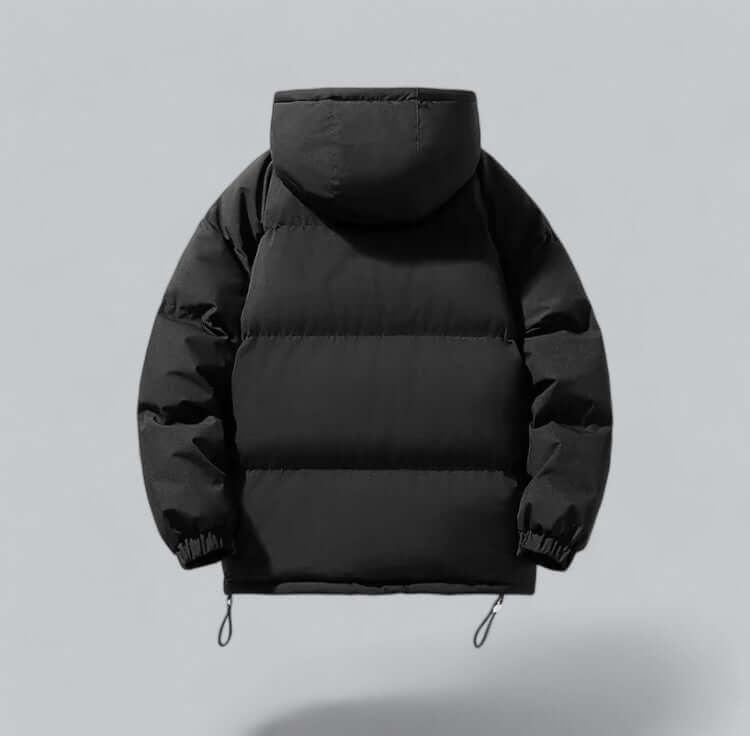 Back view of the black padded jacket, showing the horizontal quilted panels, hood and elasticated cuffs. 2